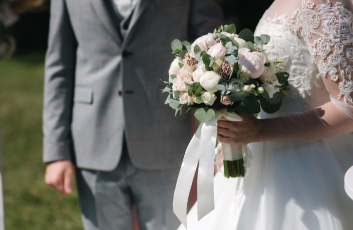 Beautiful wedding ceremony outdoors in summer time. Happy couple of groom and bride on ceremony.